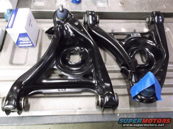 Black control arms with blue ball joint boots and a box of ACDelco parts
