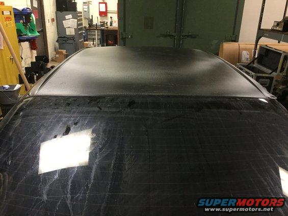 Black car roof with carbon fiber wrap and rear window with defroster lines