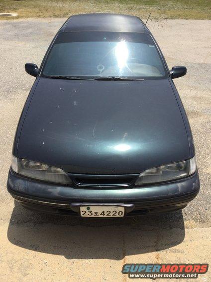 Dark sedan front view with license plate 23조4220