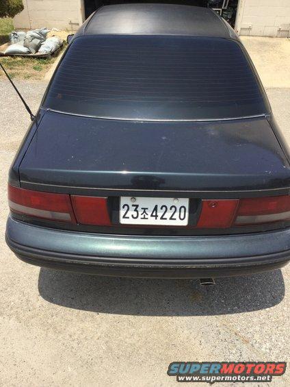 Rear view of a dark sedan with a license plate reading 23조 4220