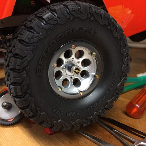 BFGoodrich All-Terrain T/A KO2 tire on a silver multi-hole wheel, with tools nearby