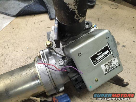 Close-up of a Koyo power steering motor and control unit with part numbers visible