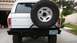 1979 Ford Bronco - The rear of a white 1979 Ford Bronco is shown, a large spare tire and a custom bumper with a Nevada license plate.