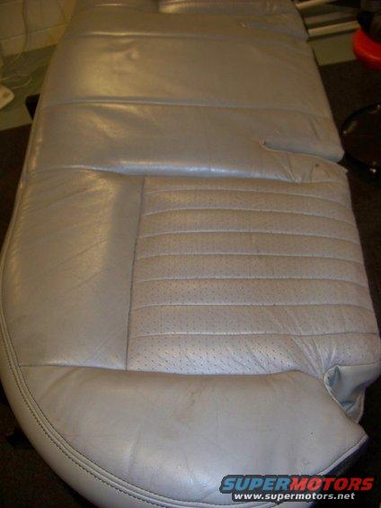 Light gray leather car seat with perforated inserts and horizontal stitching