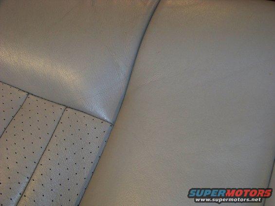 close-up of light-colored leather car seats with perforated inserts