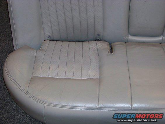 Light gray leather rear car seat with perforated inserts and stitching