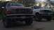 1996 Ford Bronco - Two Ford Broncos, a red one in the foreground and a white one behind it, are parked outdoors.