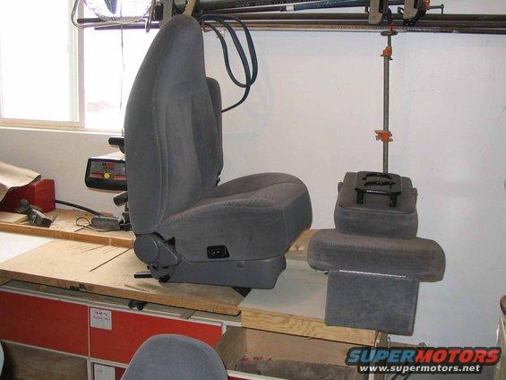 Gray car seat and center console on workbench