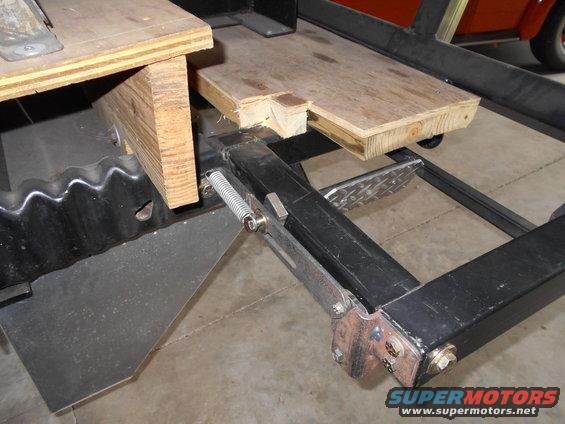 Vehicle frame with wooden supports and a spring mechanism
