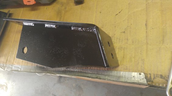 Black metal bracket with two holes on one side and one hole on the other