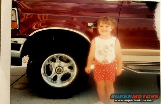 1996 Ford Bronco front fender and wheel with a young girl
