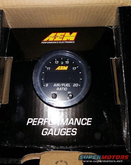 AEM Performance Electronics air/fuel ratio gauge, still in its box with "PERFORMANCE GAUGES" printed on it