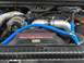 2004 Ford Excursion - Close-up of a Ford Power Stroke V8 Turbo Diesel engine with prominent blue hoses.