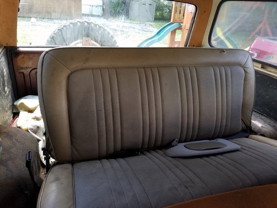 Interior rear seat and spare tire visible through the back window