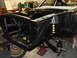 1967 Ford Mustang - The front end of a 1967 Ford Mustang is shown during a restoration project, with the chassis and suspension components visible.
