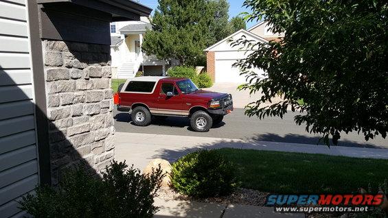 Red 1996 Ford Bronco parked on suburban street