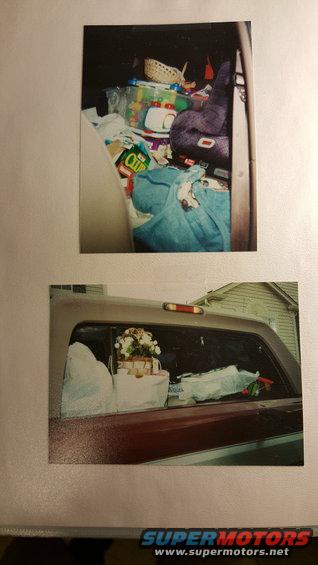 Interior of a vehicle packed with groceries, blankets, and a purple stuffed animal