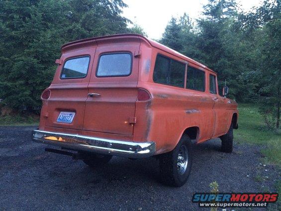 Orange panel van, rear view, with a custom spoiler and chrome bumper