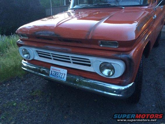 Orange truck front end with chrome bumper and Washington license plate AZR8727