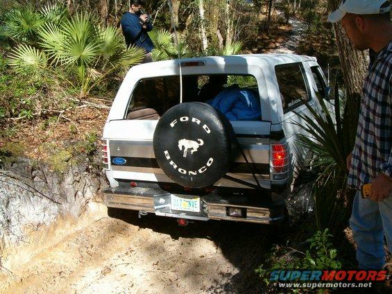 1991 Ford Bronco on a dirt trail, spare tire mounted on rear door