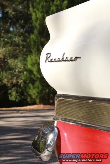 1958 Ford Ranchero emblem on white tailgate above red body and chrome bumper