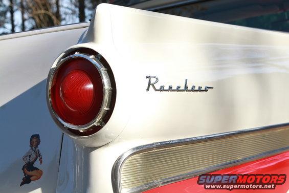 1958 Ford Ranchero rear tail fin with round taillight and chrome trim. Pin-up sticker on fender