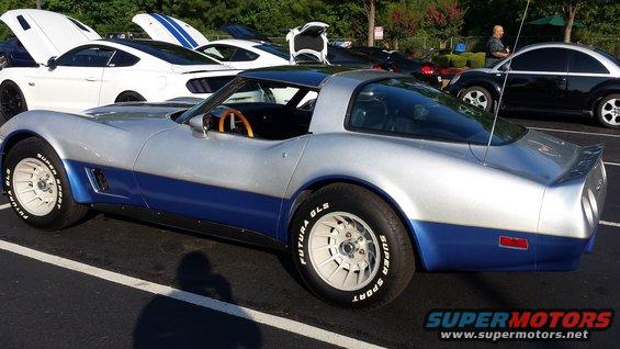 Silver and blue 1976 Chevrolet Corvette with a wooden steering wheel, seen from the side
