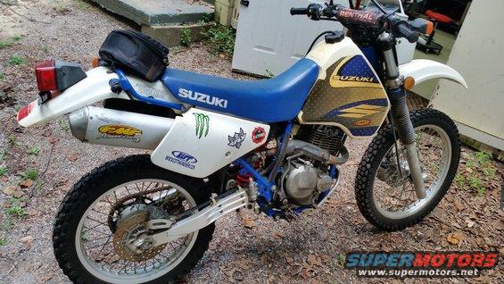 White and blue 1993 Suzuki DR350S motorcycle with FMF exhaust and Monster Energy sticker, side view