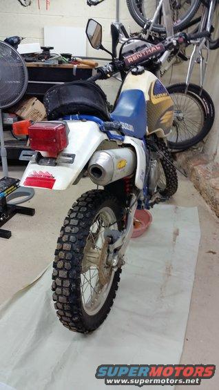 Rear view of a 1993 Suzuki DR350S motorcycle parked indoors