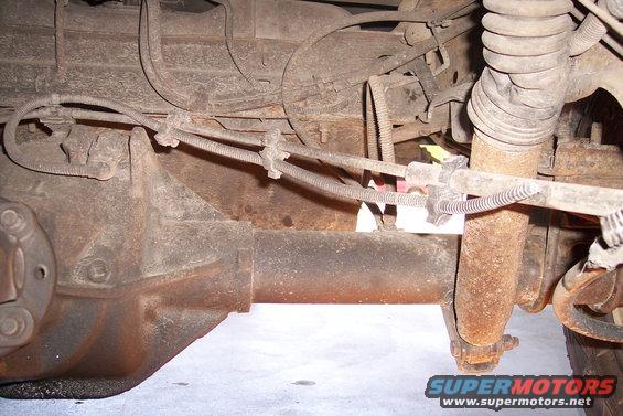 rear axle, brake lines, and shock absorber on a vehicle