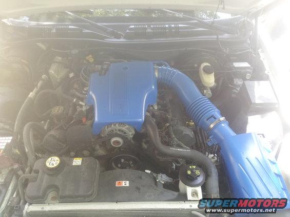 Engine bay of a 2004 Ford Crown Victoria with a blue intake system