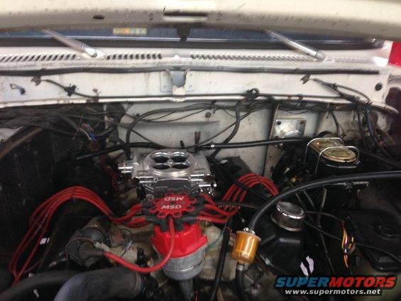 Engine bay with MSD distributor, Holley carburetor, and red spark plug wires