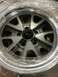 1964 Ford Fairlane - A single silver alloy wheel with a five-spoke design and polished rim is shown, partially covered in protective plastic wrap.
