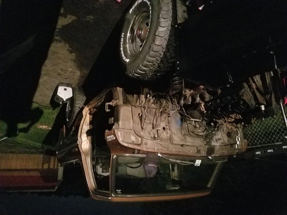 Brown 1978 Ford Bronco engine bay with hood open, showing engine and wiring