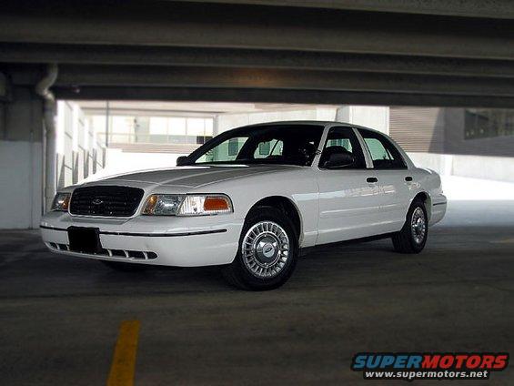 White 2000 Ford Crown Victoria parked indoors. Front quarter view