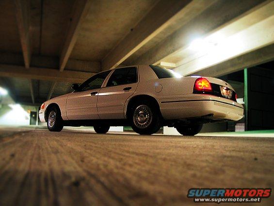 White 2000 Ford Crown Victoria rear quarter view, parked indoors, with taillights illuminated