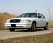 2000 Ford Crown Victoria - A white 2000 Ford Crown Victoria is shown from the front-right angle on a paved road.