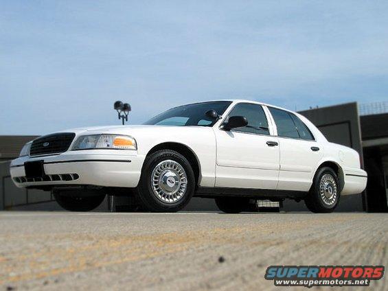 White 2000 Ford Crown Victoria, front 3/4 view, parked on concrete
