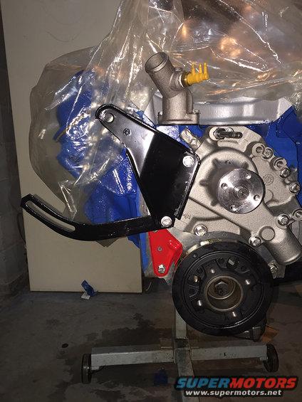 Engine assembly on a stand with blue block and black bracket