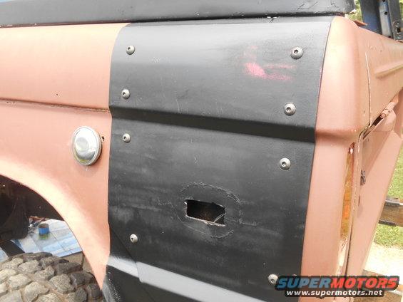 1972 Ford Bronco rear quarter panel with black trim covering a hole