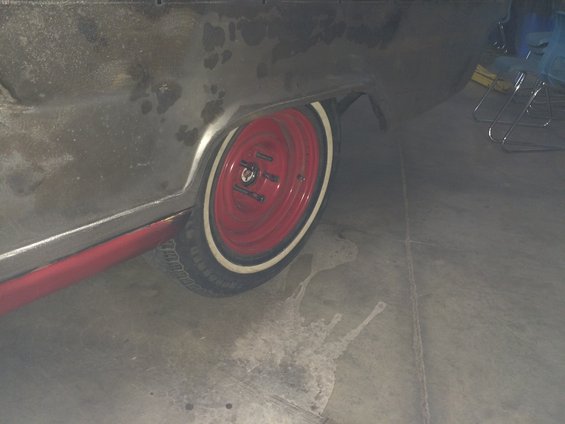 1964 Ford Fairlane rear quarter panel and red wheel with whitewall tire
