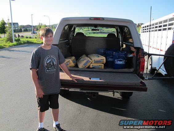 1996 Ford Bronco rear view with tailgate open, carrying bags of cement and buckets