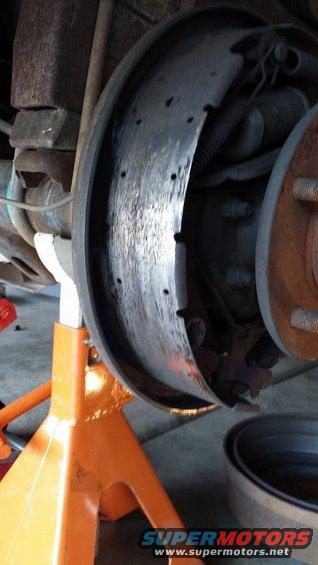 close-up of a vehicle's drum brake assembly on an orange jack stand