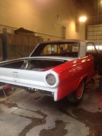 1964 Ford Fairlane rear view, red and white, in garage