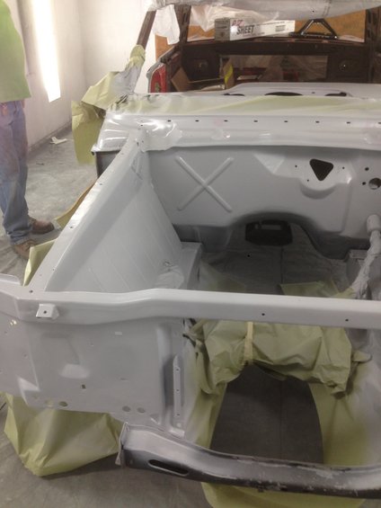 1964 Ford Fairlane body, primed and masked for paint. Engine bay area is visible