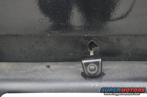 backup camera mounted on black textured surface