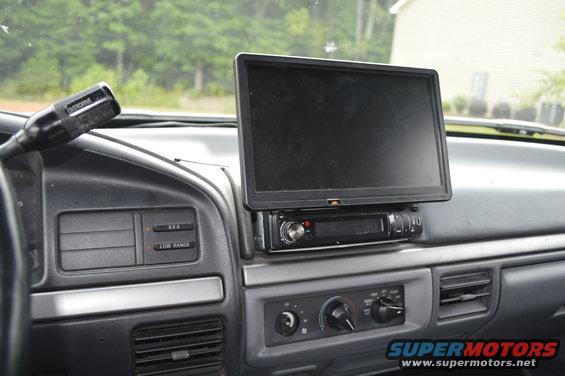 Dashboard of a truck with a screen and radio installed. Gear shifter visible