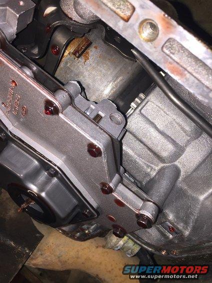 image_2.jpeg this is a shot of the inside of the C6 transmission in my bronco after i first dropped the pan.  this shot is from laying under the vehicle, lookin up on the driver's side of the transmission.  the front of the vehicle is towards the top left corner of the photo.  the valve body is on the left middle of the photo.  what i wanted to get a picture of is the planetary shell, which is in the top middle of the photo.  it appears to have a little rust on it, indicating that the water in the transmission did some damage to it.  at the time of this writing, i am not sure if the transmission will still work or not.  i will find out once i get the new motor put in.  also note the glob of slime hanging from the filter screen in middle left of the photo.  this is the same slime that was in the bottom of the pan.