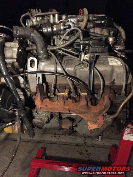drivers side of the engine as i got it.  you cant see it here but under the exhaust manifold i found one of those heat tabs glued in place.  also there is some paint on the block.  looks like the engine may have been rebuilt.