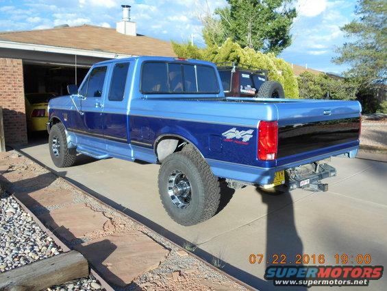Blue two-tone Ford F-250 pickup truck parked in a driveway